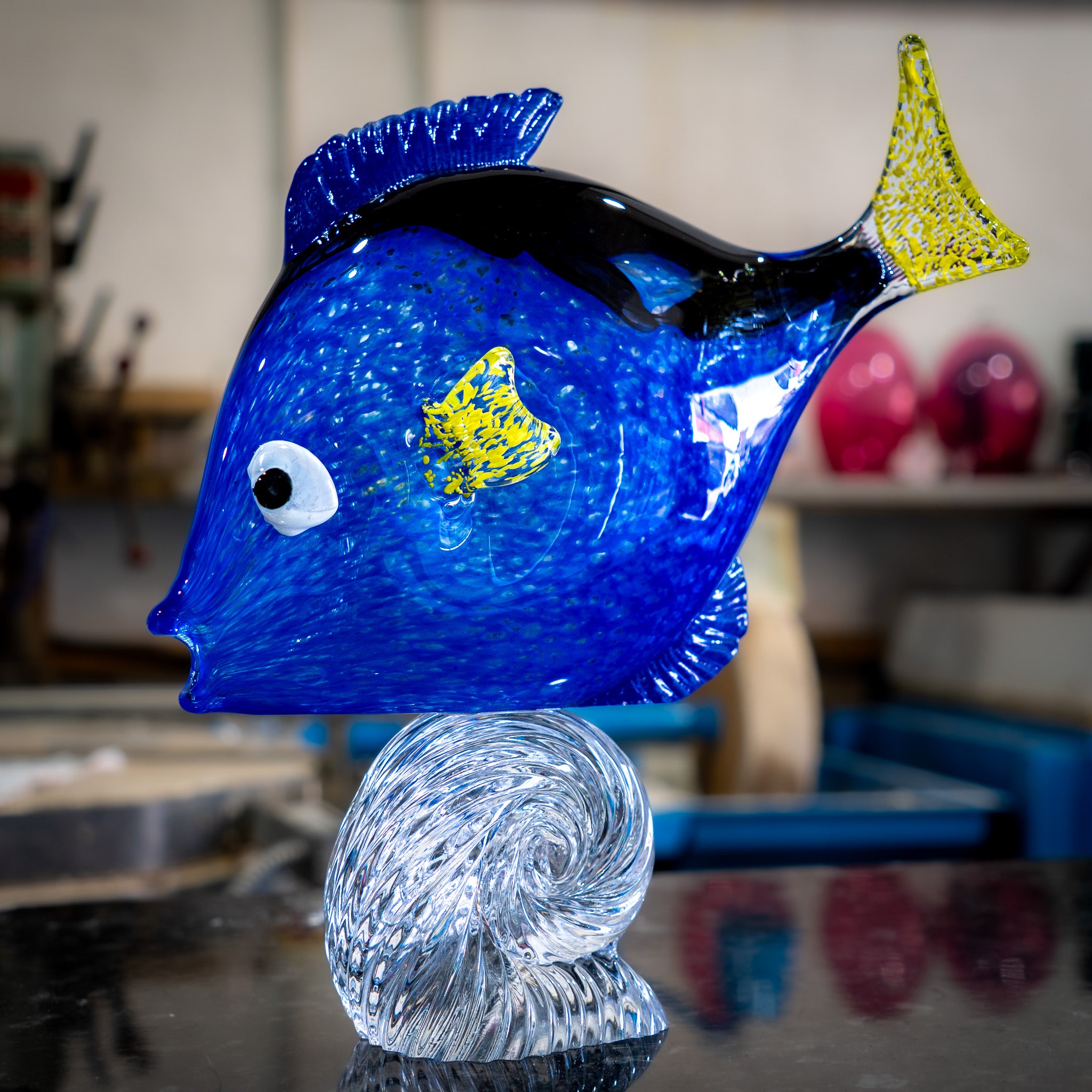 Hand-blown glass Dory surfing a wave